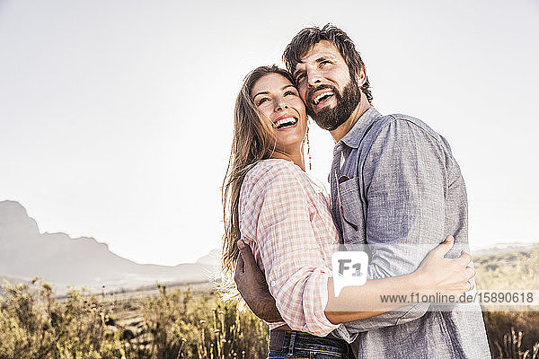Portait of happy couple in barren landscape