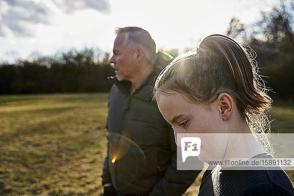 Portrait of girl with her father on a meadow