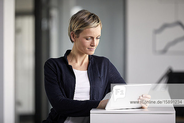 Businesswoman using tablet in office