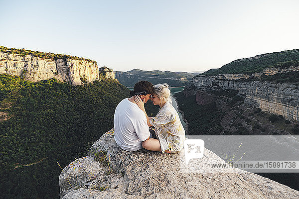 Young couple in love sitting on viewpoint  Sau Reservoir  Catalonia  Spain