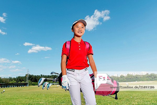 Outdoor happy children carrying a golf bag