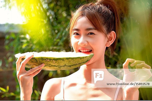 Girls eat watermelon in the outdoor