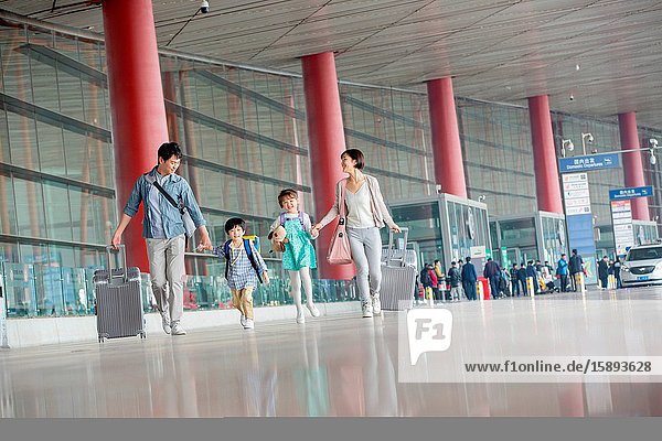 A happy family with luggage at the airport