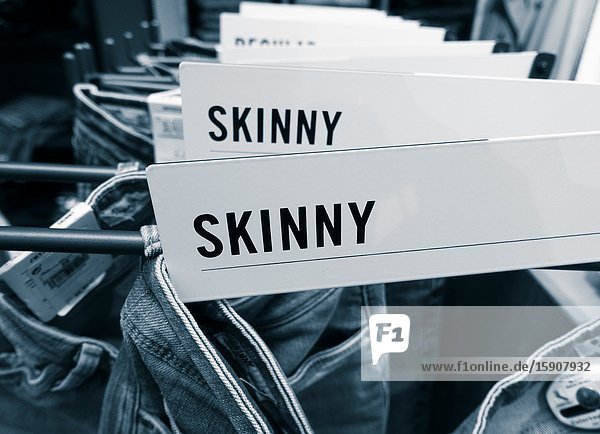 Skinny jeans display in clothing store.