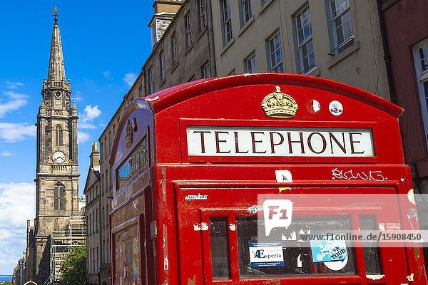 Typical British red telephone booth The Tron Kirk church on background Royal Mile Old Town Edinburgh Scotland United Kingdom Europe.