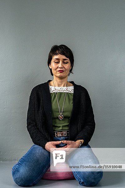 Tilburg Netherlands. Studio Portrait of an adult Dutch woman and mother with Indonesian roots.