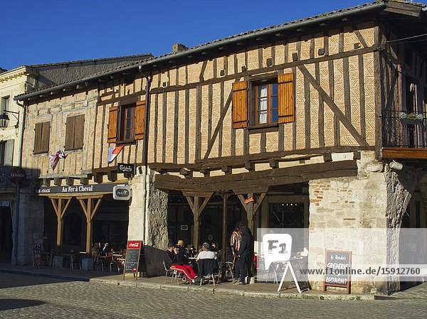 Half-timbered buildings and cafes Place de la Halle Villereal Lot-et-Garonne Department Nouvelle-Aquitaine France.