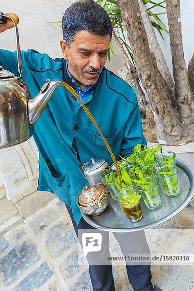 Man pouring mint tea at medina. Tunis city. Tunisia Africa.