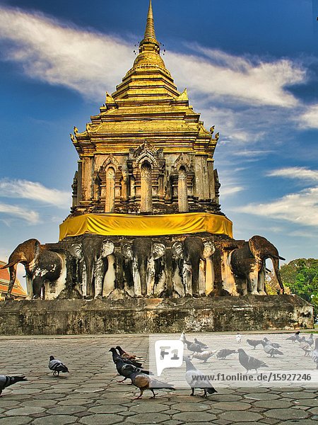 Stupa at Wat Chiang Man with pigeons Chiang Mai Thailand.