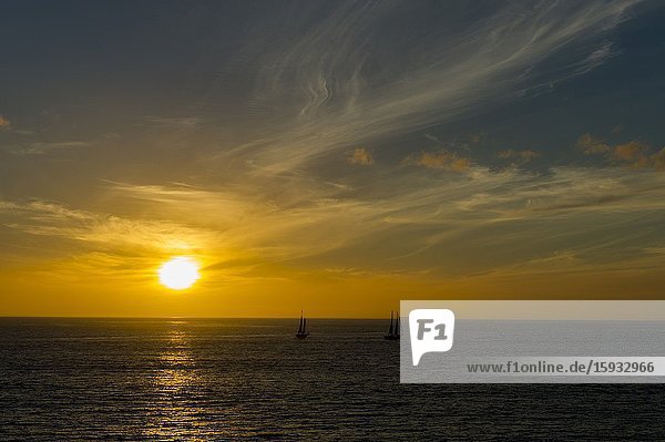 Sunset over the Atlantic Ocean with Sailboats near Cape Town  South Africa.