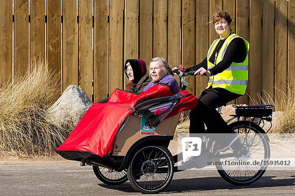 Taking the elderly out for a refreshing trip to beach front. Montrose Scotland UK.