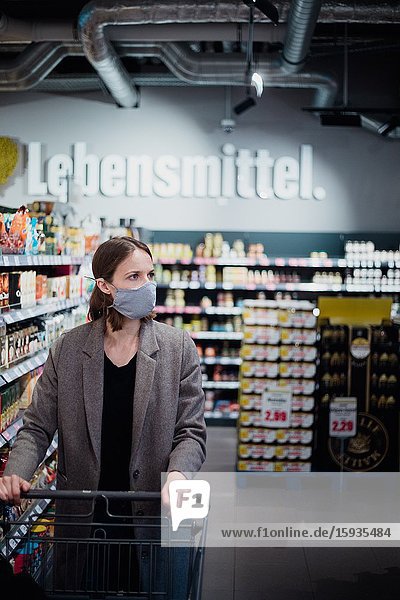 Woman with mask in supermarket.