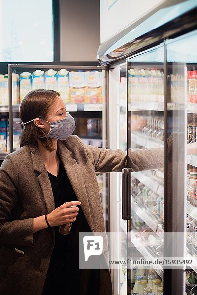 Woman with mask in supermarket.