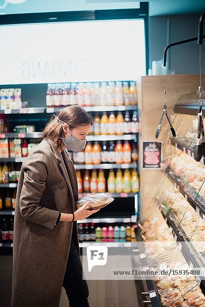 Woman with mask in supermarket.