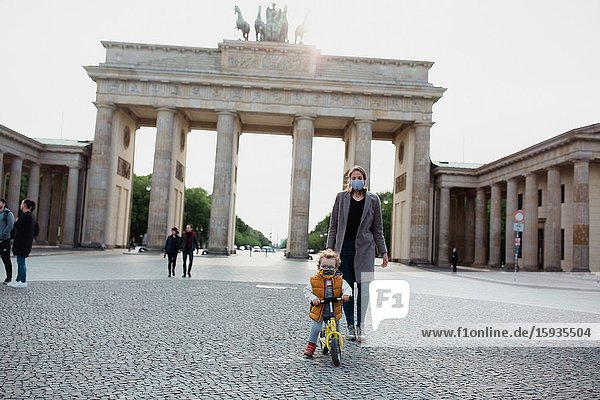 Mother and son walking in Brandenburg gate in Berlin in Corona days.