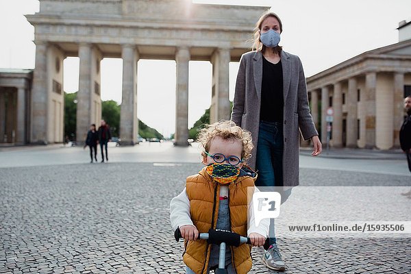 Mother and son walking in Brandenburg gate in Berlin in Corona days.