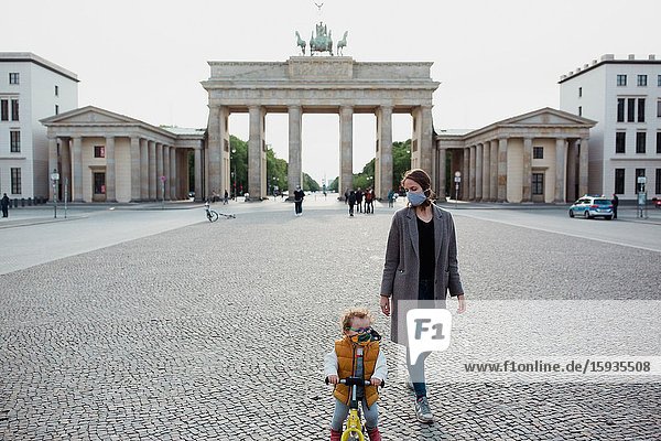 Mother and son walking in Brandenburg gate in Berlin in Corona days.