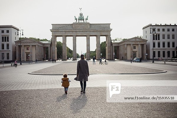 Mother and son walking in Brandenburg gate in Berlin in Corona days.