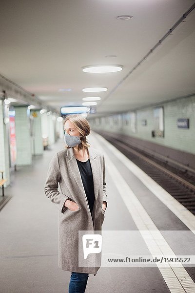 Woman using public transportation with mask during Corona days.
