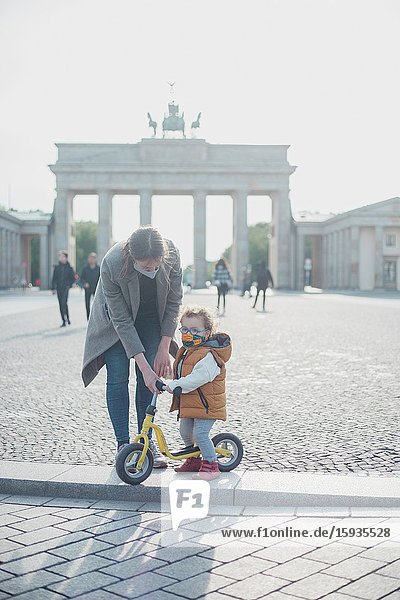 Mother and son walking in Brandenburg gate in Berlin in Corona days.