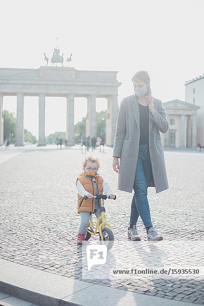 Mother and son walking in Brandenburg gate in Berlin in Corona days.