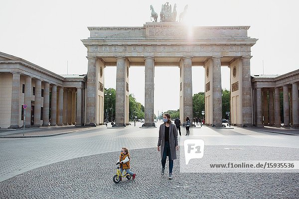Mother and son walking in Berlin in Corona days.