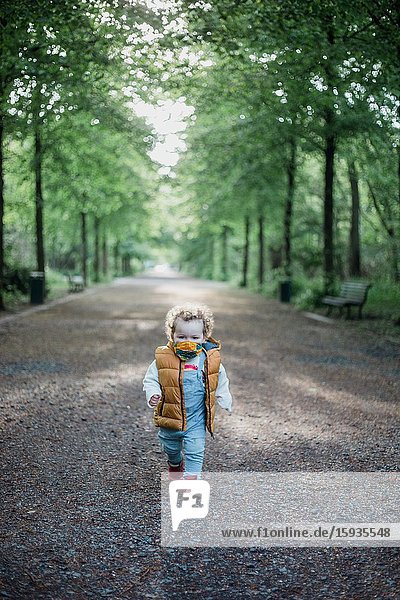 Little boy 2-3 Years old wih mask in the park.