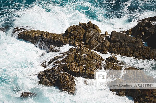 High Angle View of Waves Crashing on Rocks