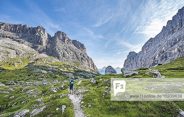 Hiker  mountaineer on a trail between rocky mountains  Sorapiss circuit  Dolomites  Belluno  Italy  Europe