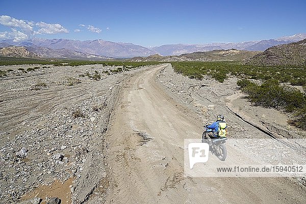 Motorcyclists on gravel road  near Uspallata  Mendoza Province  Argentina  South America
