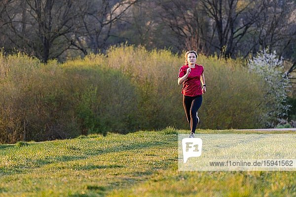 Woman  23 years  jogging on the meadow  Germany  Europe