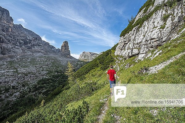 Junger Wanderer auf dem Wanderweg Sentiero Carlo Minazio  hinten Bergspitze des Torre dei Sabbioni  Sorapiss Umrundung  Dolomiten  Belluno  Italien  Europa