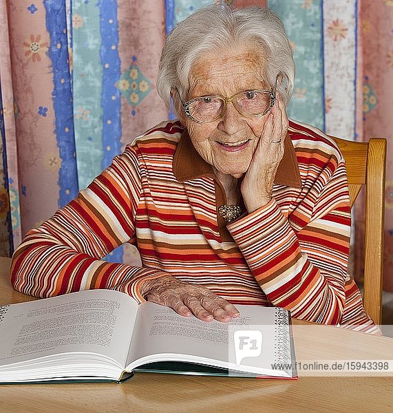 Senior citizen reading a book at home  Austria  Europe