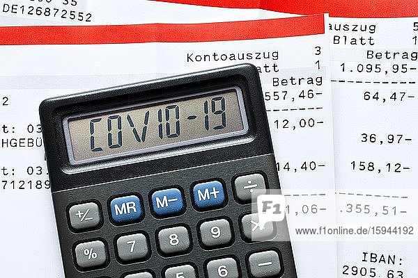 Digital Composing  Calculator with Covid-19 lettering and account statements  payments  symbolic photo for the effects of the Corona crisis on the economy  Germany  Europe