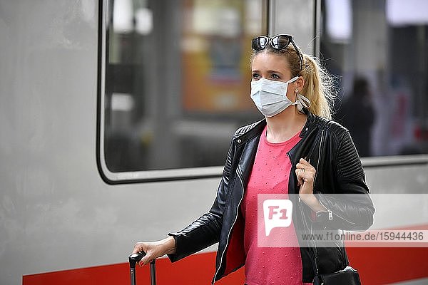 Woman with face mask  waiting for train  corona crisis  main station  Stuttgart  Baden-Württemberg  Germany  Europe