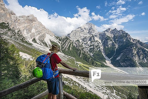 Hiker looking at the peaks of Cima Scooter and Cima Salvella  ascent to the Rifugio San Marco  San Vito di Cadore  Belluno  Italy  Europe