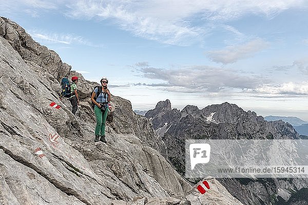 Female mountaineers on marked route through rocky alpine terrain  from Simonyhütte to Adamekhütte  Salzkammergut  Upper Austria  Austria  Europe