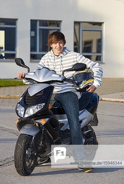 Young person sitting on scooter  Upper Austria  Austria  Europe