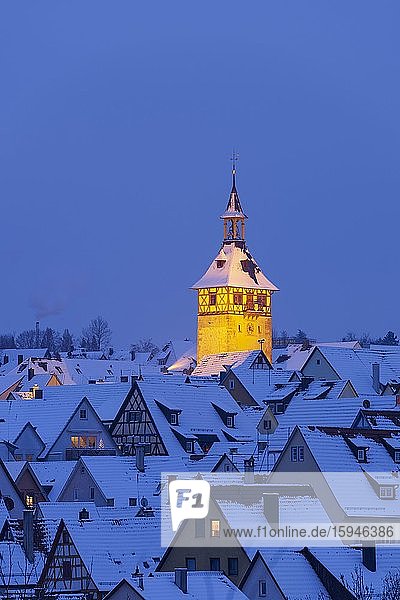View over snowy roofs of the old town with illuminated church tower,  evening mood,  Marbach am Neckar,  Baden-Württemberg,  Germany,  Europe