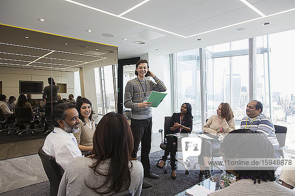 Smiling businessman leading meeting in office