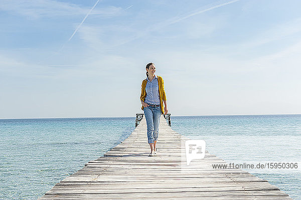 Happy woman walking on jetty  Mallorca  Spain