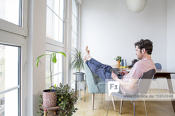 Man using tablet at home