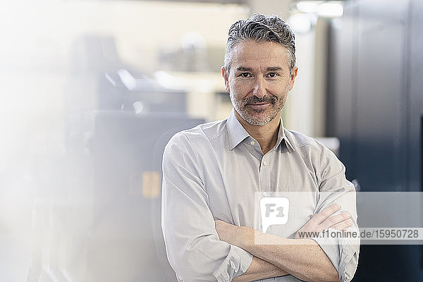 Portrait of a mature businessman standing in company