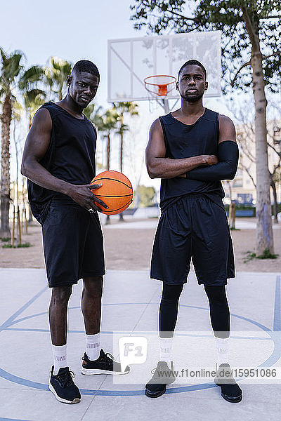 Young men with basketball on basketball court