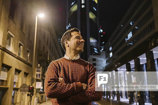 Happy businessman in the city at night  Frankfurt  Germany
