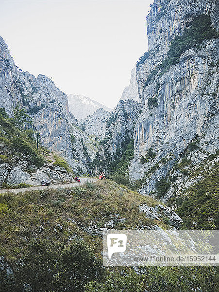 Spanien  Kantabrien  Wanderin rastet entlang der Strasse im felsigen Tal der Picos de Europa