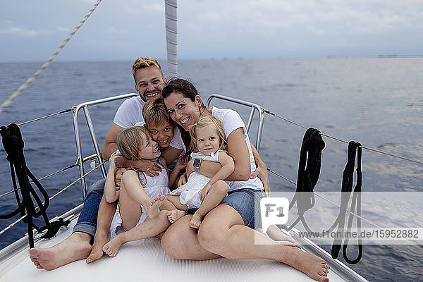 Family sitting on deck during sailing trip