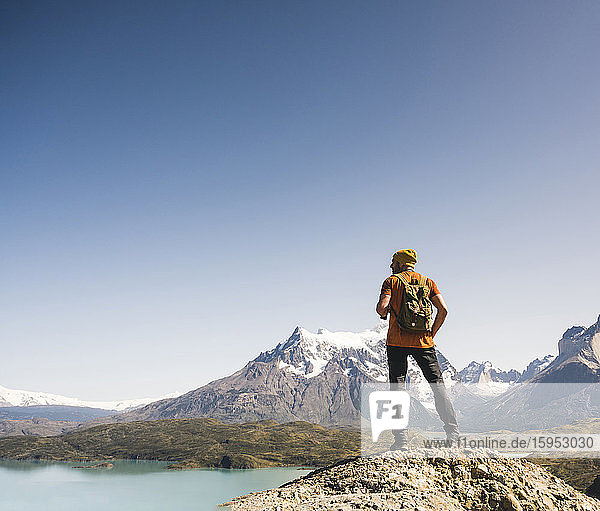 Hiker in mountainscape at Lago Pehoe in Torres del Paine National Park  Patagonia  Chile