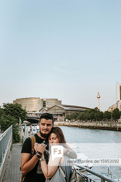 Young couple hugging at River Spree  Berlin  Germany