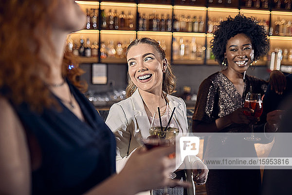 Happy friends socializing in a bar